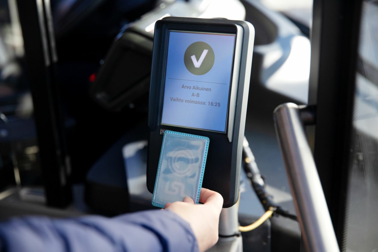 Kuva matkakortin leimaamisesta bussissa.